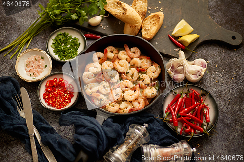 Image of Tasty shrimp tails fried in butter with, garlic, parsley, white wine chili. With various ingredients