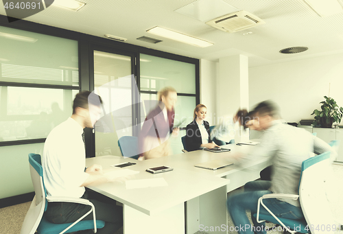 Image of business people group entering meeting room, motion blur