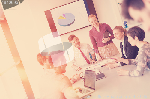 Image of startup business team on meeting at modern office with sunset in