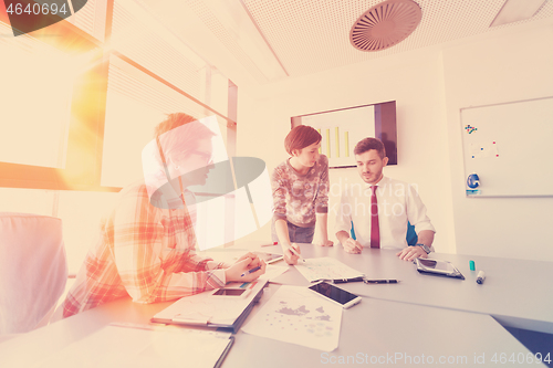 Image of startup business team on meeting at modern office with sunset in