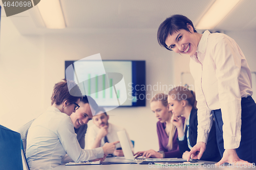 Image of young  woman using  tablet on business meeting