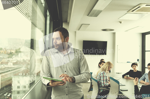 Image of Businessman Using Tablet In Office Building by window