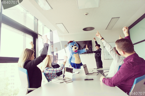 Image of boss dresed as bear having fun with business people in trendy of