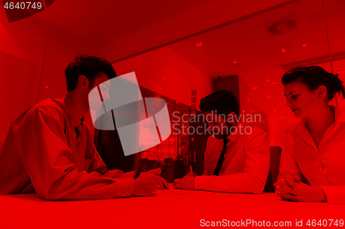 Image of young couple signing contract documents on partners back