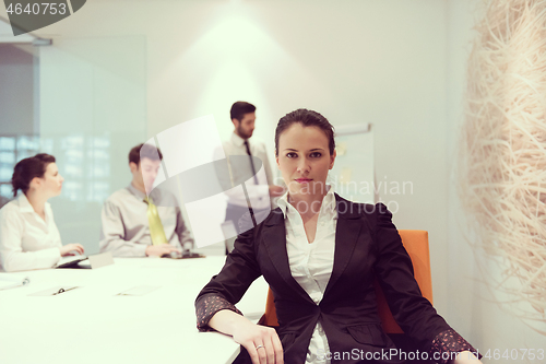 Image of young business woman on meeting  using laptop computer