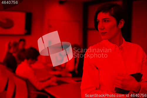 Image of hispanic businesswoman with tablet at meeting room