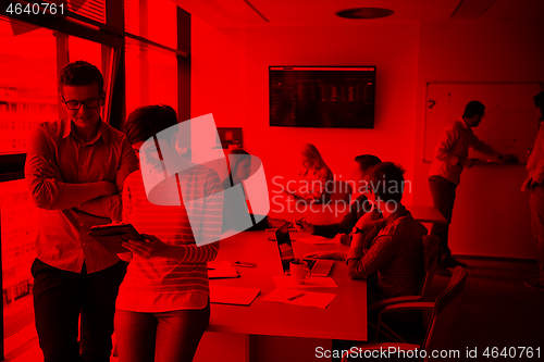 Image of Two Business People Working With Tablet in office