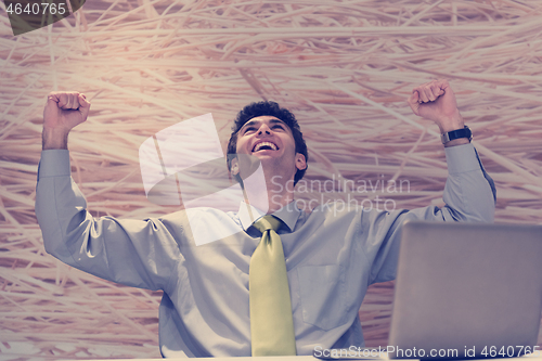 Image of young business man  working on laptop  computer at modern office