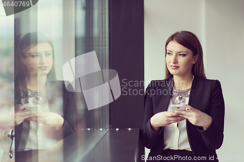 Image of Business Girl Standing In A Modern Building Near The Window With