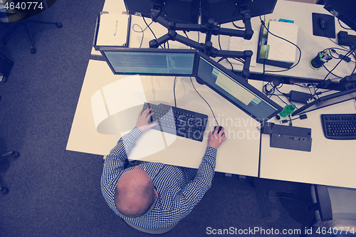 Image of young programmer writing programming code top view