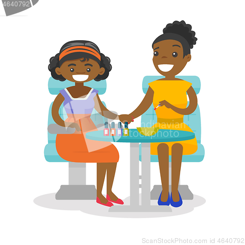 Image of African woman getting manicure at beauty salon.