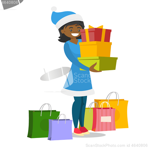 Image of Young woman in santa hat buying christmas gifts.