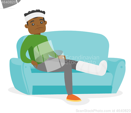 Image of African man with broken leg sitting on the couch.