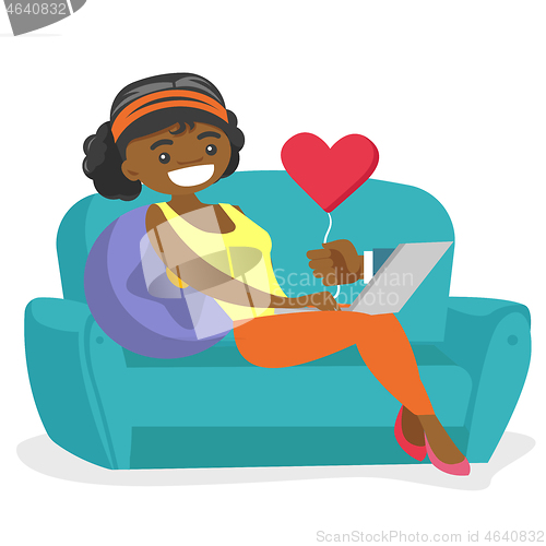 Image of African-american woman dating online using laptop.