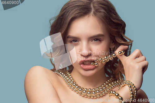 Image of Beautiful young girl in studio with pearl jewelry - earrings, bracelet, necklace.