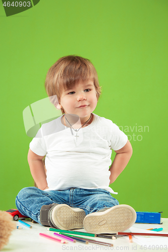 Image of Portrait of happy little boy over green background