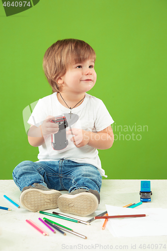 Image of Portrait of happy little boy over green background