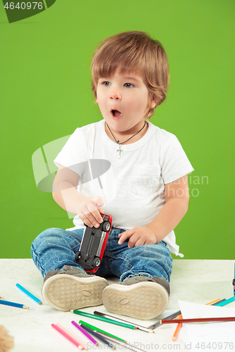 Image of Portrait of happy little boy over green background