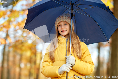 Image of happy girl with umbrella at autumn park