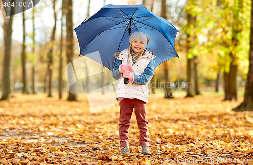 Image of happy little girl with umbrella at autumn park