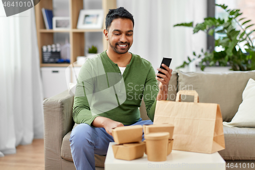 Image of indian man using smartphone for food delivery