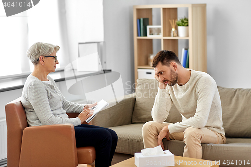 Image of senior woman psychologist and sad man patient