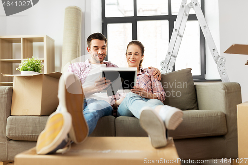 Image of happy couple with boxes moving to new home