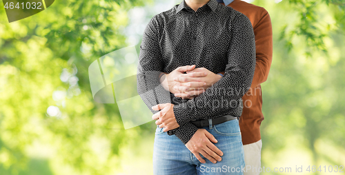 Image of close up of hugging male gay couple