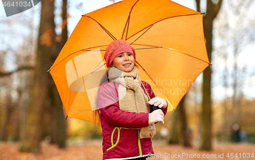 Image of happy little girl with umbrella at autumn park