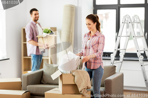 Image of happy couple with stuff moving to new home