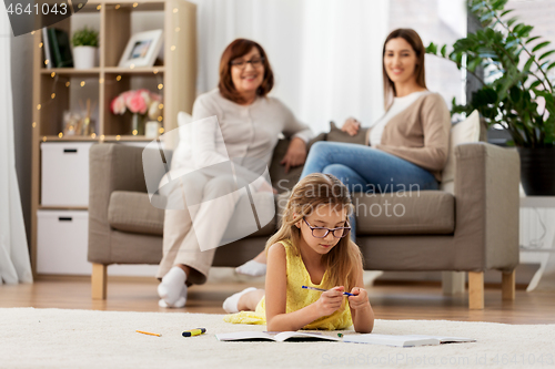 Image of student girl with notebook lying on floor at home