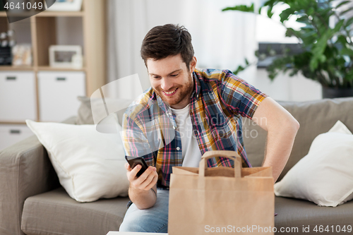 Image of man using smartphone for food delivery