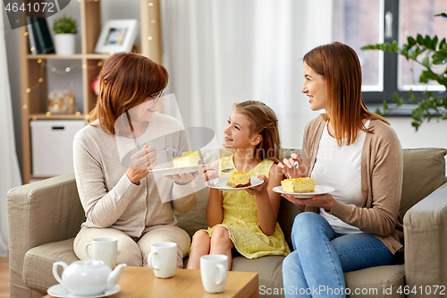 Image of mother, daughter and grandmother eating cake