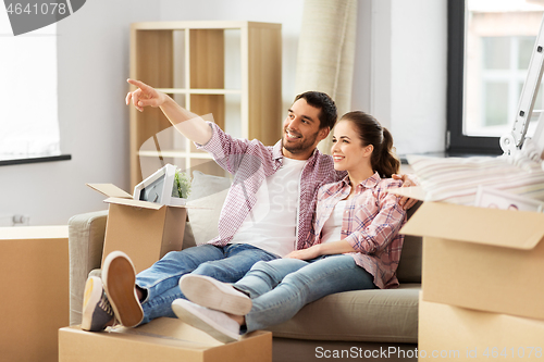 Image of happy couple with boxes moving to new home