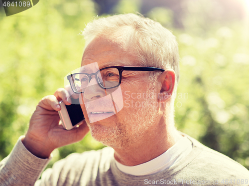 Image of happy senior man calling on smartphone in city