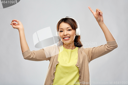 Image of asian woman in headphones listening to music