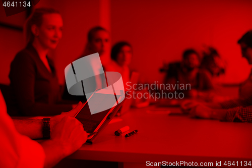 Image of close up of  businessman hands  using tablet on meeting