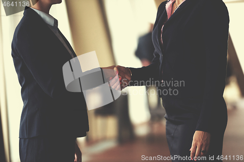 Image of business womans make deal and handshake