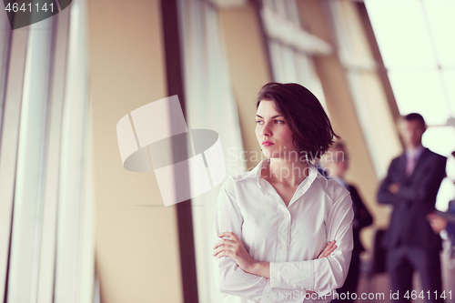 Image of business people group, woman in front  as team leader