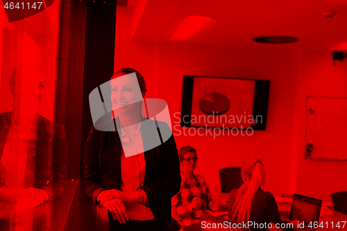 Image of portrait of young business woman at office with team on meeting 