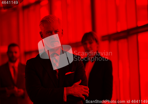 Image of senior business man with his team at office