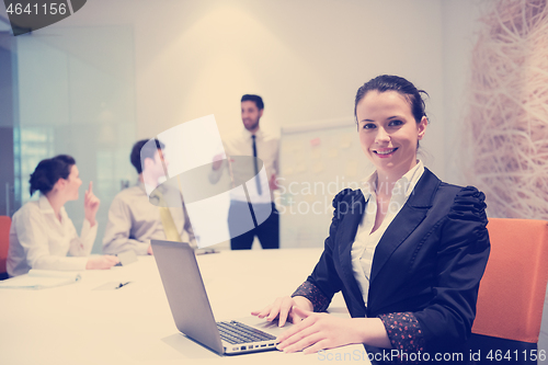 Image of young business woman on meeting  using laptop computer