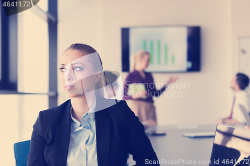 Image of portrait of young business woman at office with team on meeting 