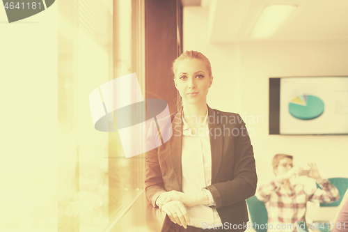 Image of portrait of young business woman at office with team on meeting 