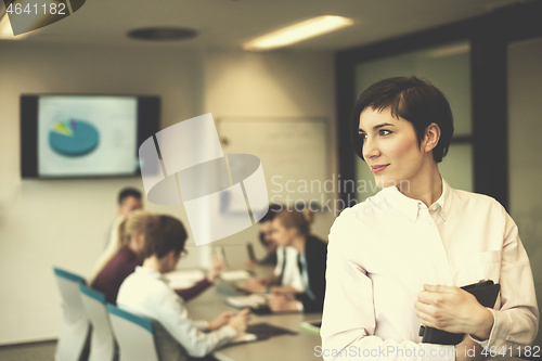 Image of hispanic businesswoman with tablet at meeting room