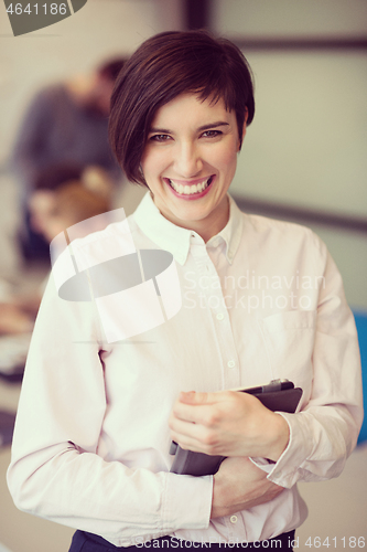 Image of hispanic businesswoman with tablet at meeting room