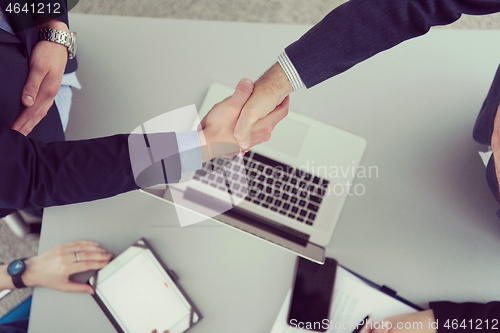 Image of cloasing the deal in modern office interior top view