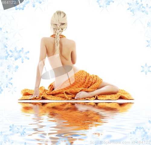 Image of beautiful lady with orange towels on white sand