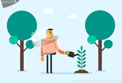 Image of Young caucasian white gardener watering plant.