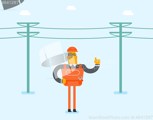 Image of Electrician repairing an electric power pole.